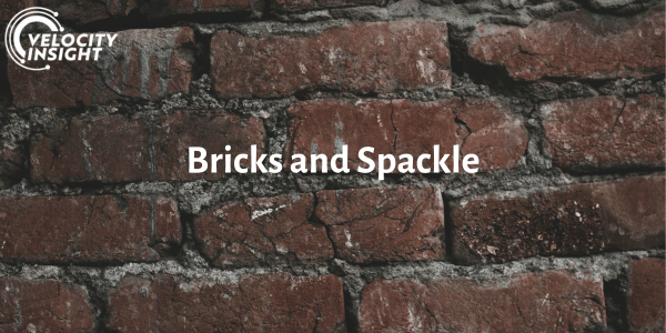 The Velocity Insight logo overlaid onto a photo of a red brick wall and the words, "Bricks and Spackle" in white.